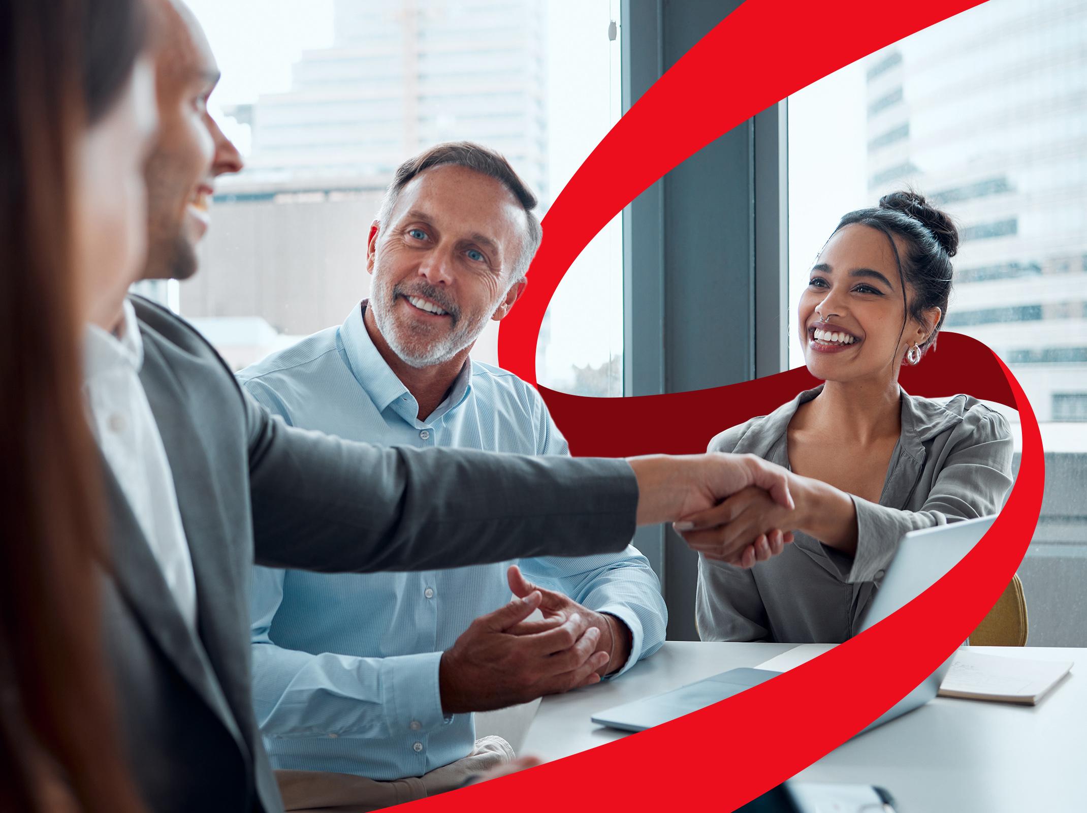 Business team finalizing contract negotiations with a handshake