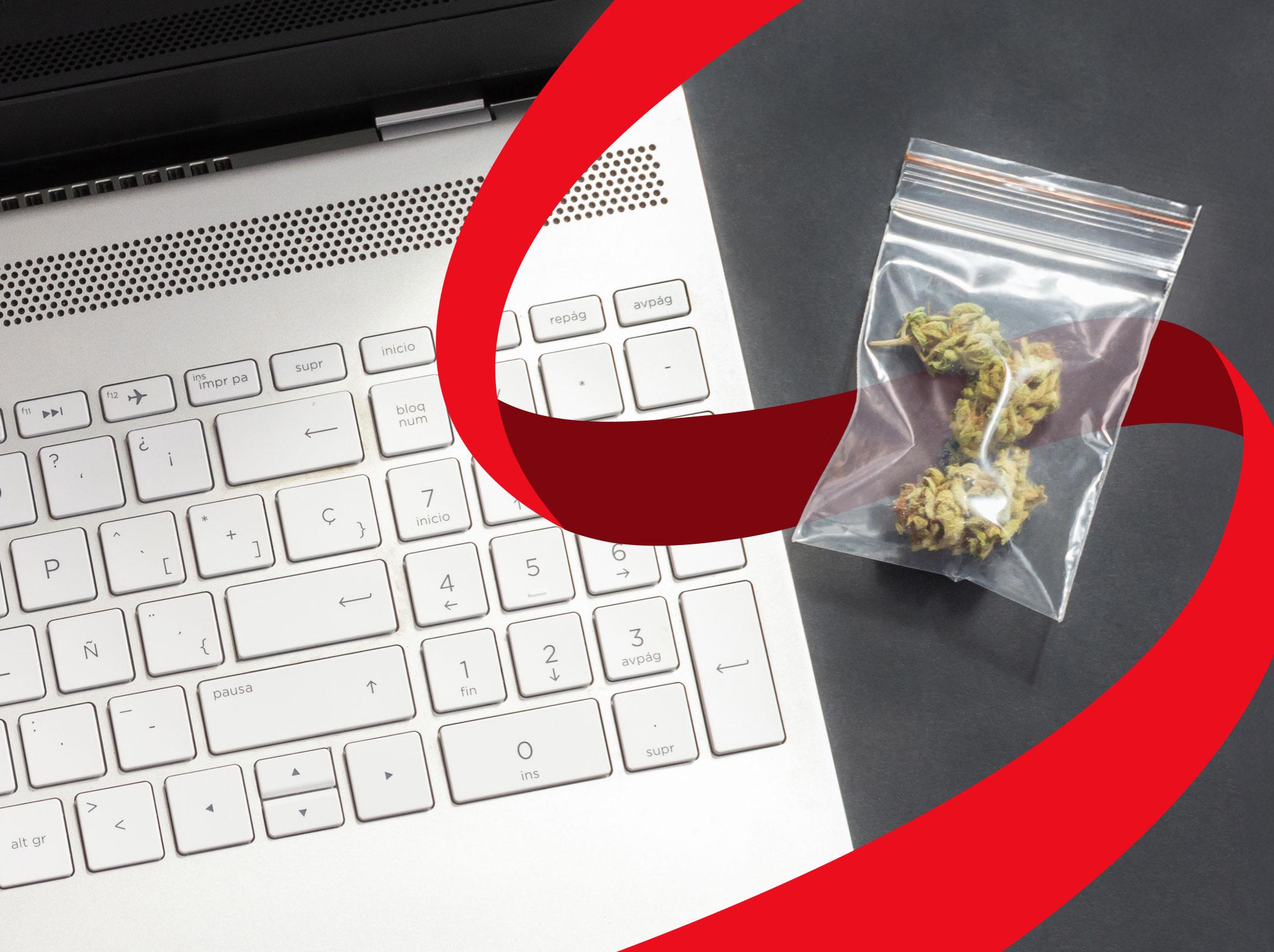 A bag of marijuana sitting next to a laptop