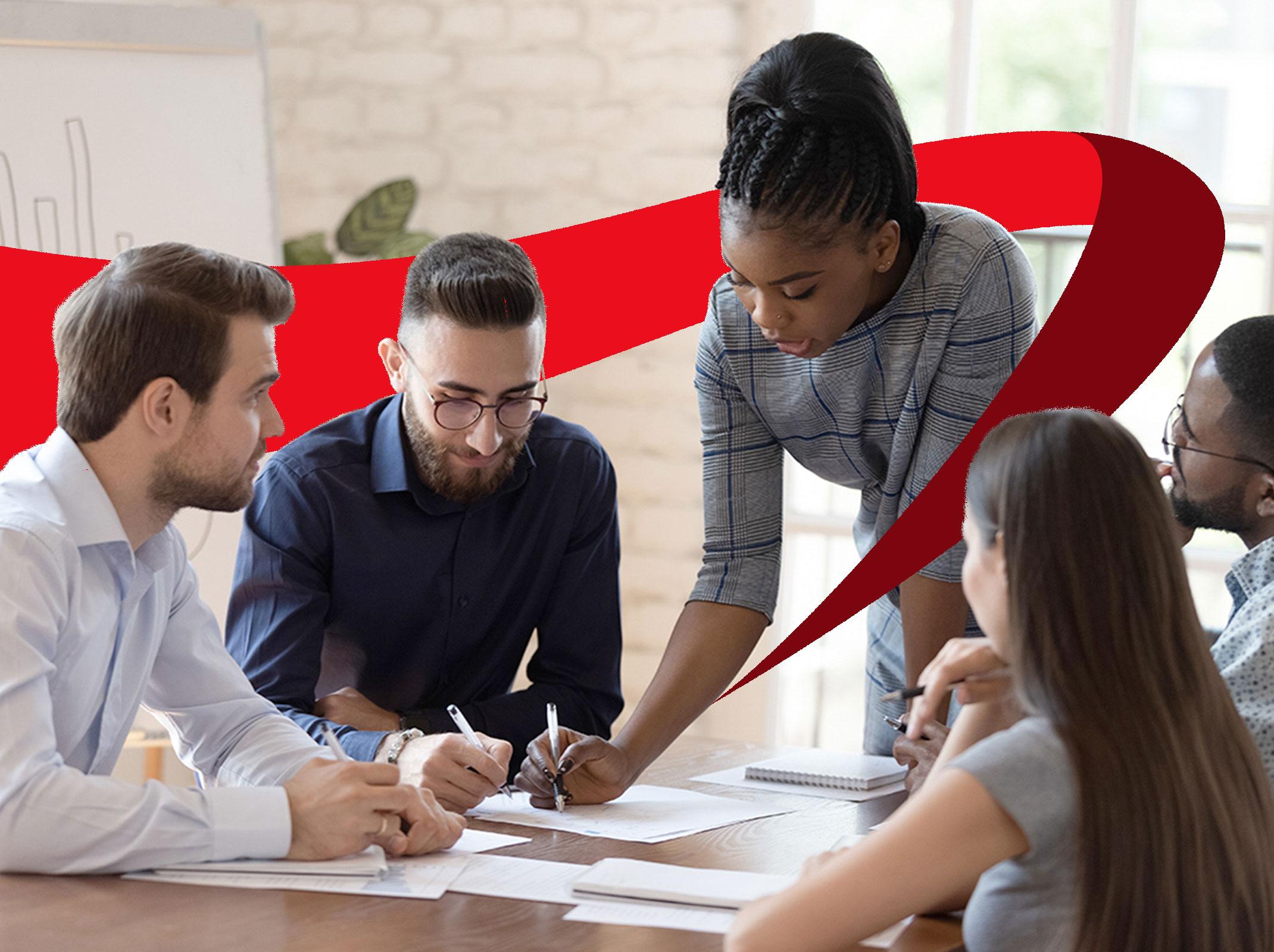 Leader explaining something at a conference table to her team